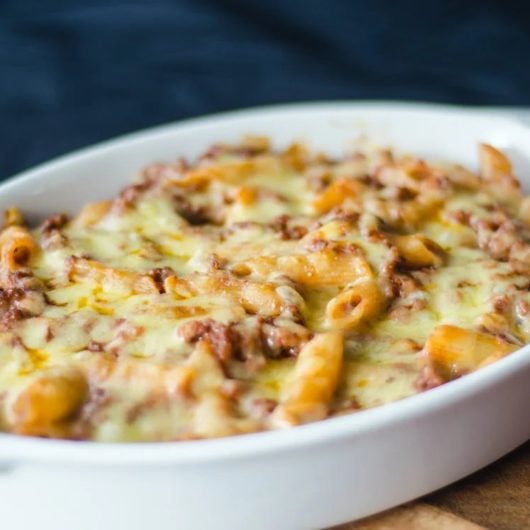 Golden baked macaroni and cheese in a bowl, served hot out of the oven.